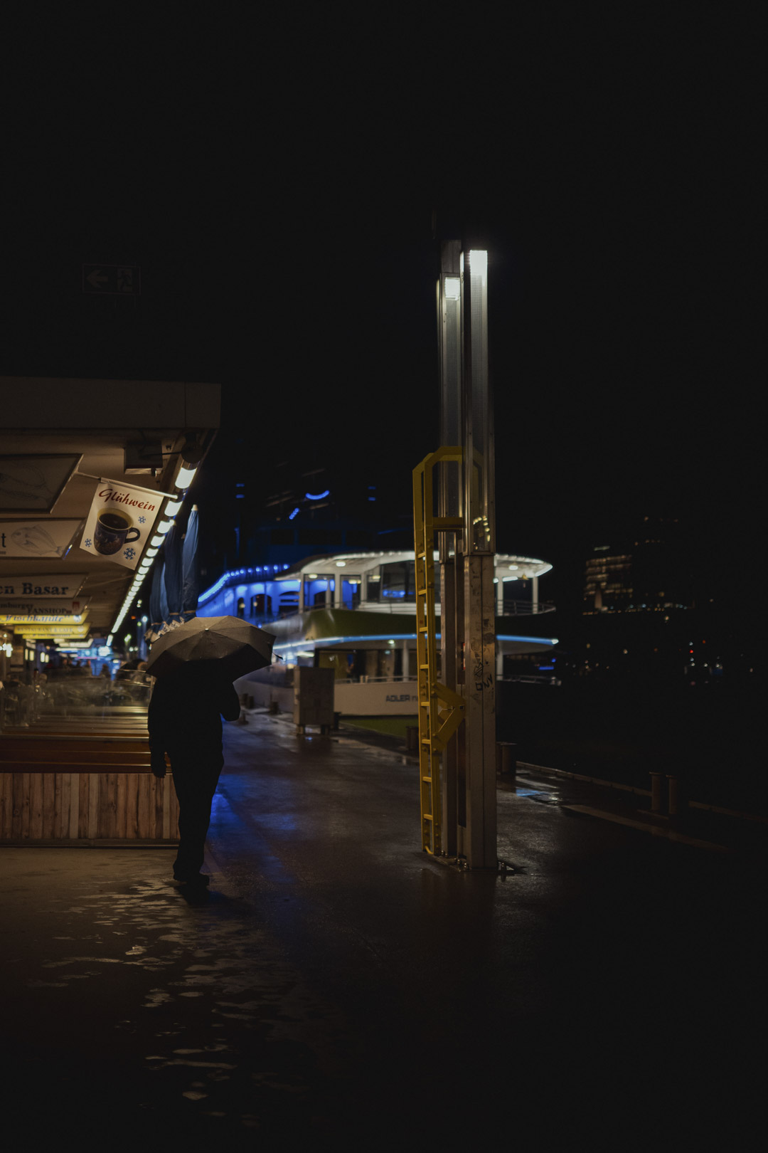 Desde paraguas hasta charcos, la lluvia puede traer un estado de �nimo y una narrativa adicionales a las escenas nocturnas de la calle. Nikon Z50II + NIKKOR Z DX MC 35mm f/1.7. | 1/640 seg, f/1.7, ISO 1600.